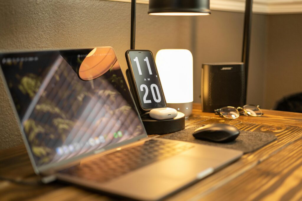 The phone is propped beside the laptop, both screens visible at a glance.